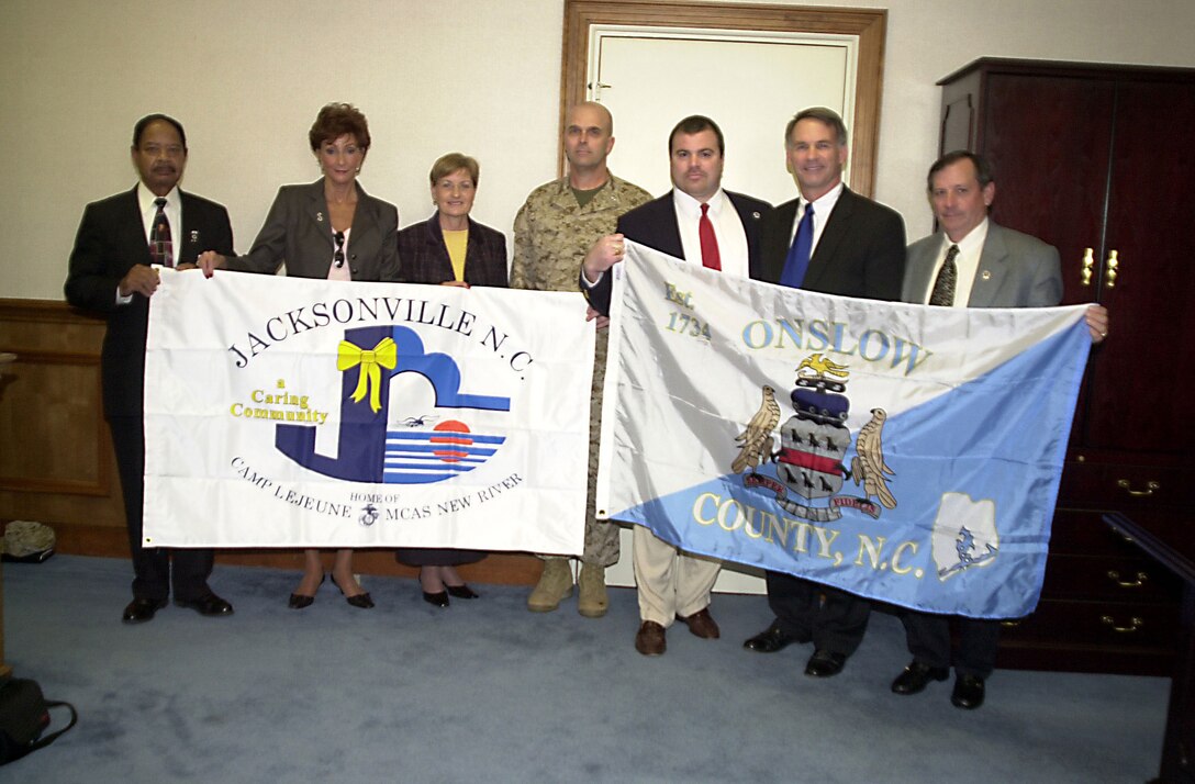 Jacksonville City Councilman Turner Blunt, Jacksonville Mayor Jan B. Slagle, Jacksonville?Onslow Chamber of Commerce President, Mona Padrick, and Onslow County Commissioners Martin Aragona, Joe McLaughlin, and Paul Buchanan present the city and county flags to Maj. Gen. Stephen T. Johnson, Commanding General, II Marine Expeditionary Force Forward.  The flags were donated on behalf of Project CARE (Community Action Readiness Effort), a program that combines the efforts local government, military, Chamber of Commerce and community organizations to provide assistance to families of deployed military.