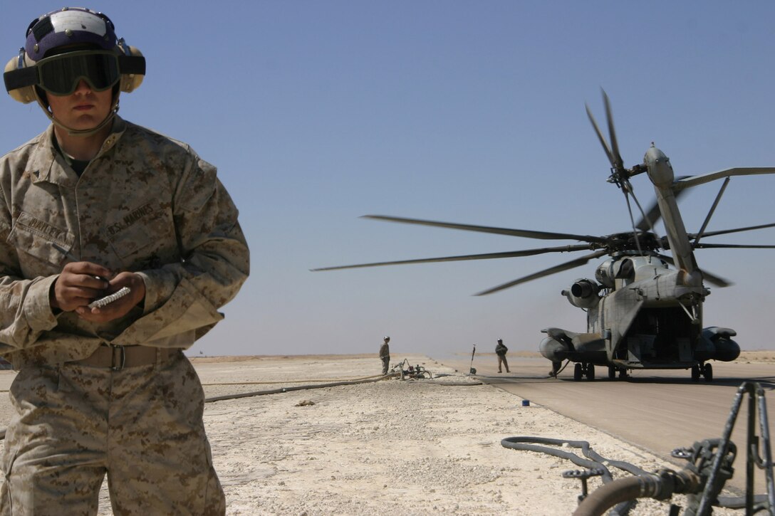 AL ASAD, Iraq- Lance Cpl. John Bailey, bulk fuel specialist, MWSS-271, writes down the aircraft identification number on a CH-53E Super Stallion while in the bulk fuel pits here March 18. Bailey is one of the 18 fuels Marines who augmented to Marine Wing Support Squadron 271 from MWSS-273 in Beaufort, S.C.
