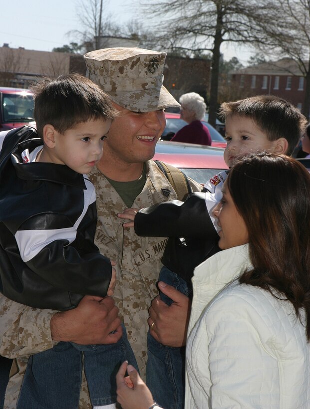 MARINE CORPS BASE CAMP LEJEUNE, N.C. - A happy father with Company C, 2d Combat Engineer Battalion holds his twin sons March 15 after returning from a seven-month deployment in the Al Anbar Province of Iraq. While in Iraq, Company C provided engineering support and humanitarian assistance during Operation Iraqi Freedom.