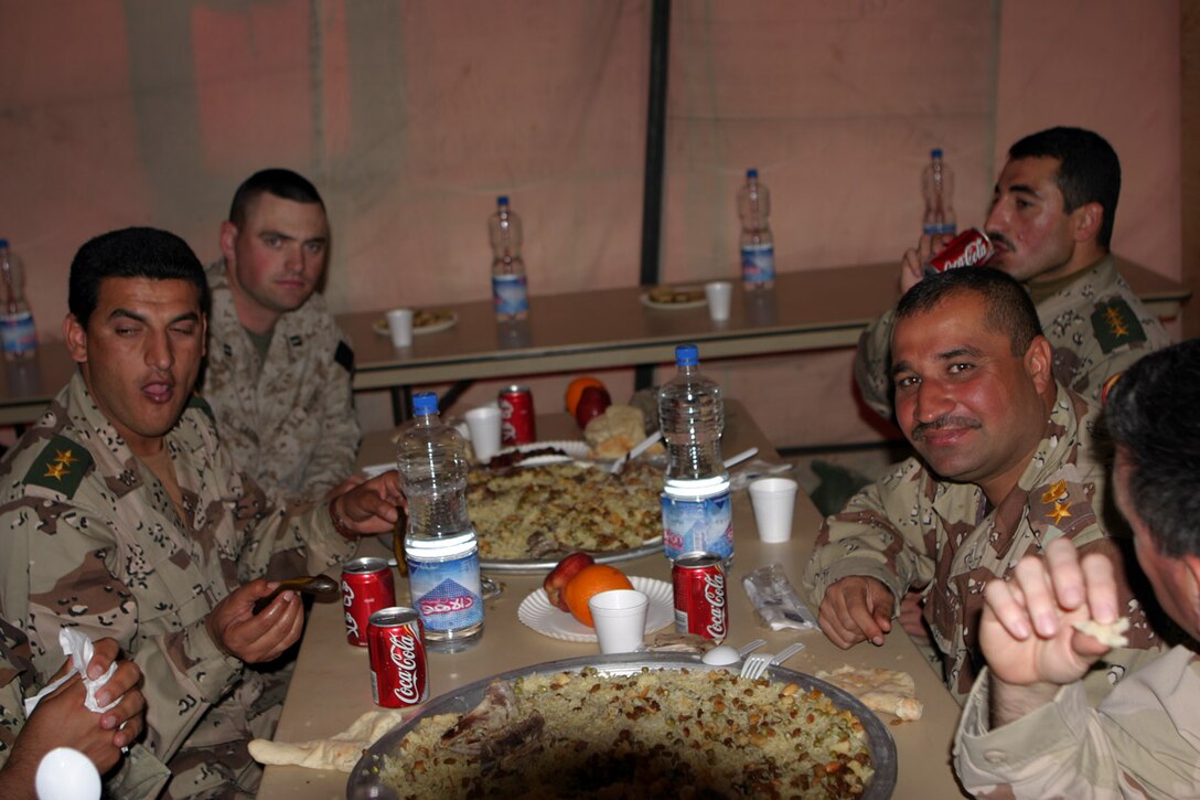 CAMP FALLUJAH, IRAQ -- Sitting down to dinner, Iraqi Security Force commanders and Marines from 3rd Battalion, 8th Marine Regiment enjoy conversation about their new Command Operations Center just recently built.  Official U.S. Marine Corps Photo by Lance Cpl. Athanasios L. Genos
