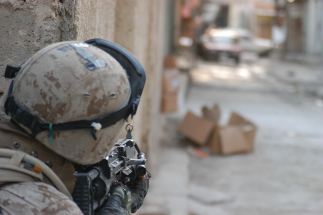 AR RAMADI, Iraq (March 18, 2005) - Nineteen-year-old Lance Cpl. Joshua A. Shores, squad automatic weapon gunner, 1st Squad, 1st Platoon, Company A, of New Richmond, Wis., provides security down a narrow street here while he and his Marines conduct a patrol. Marines with Company A, 1st Battalion, 5th Marine Regiment patrolled through the busy marketplace here in an effort to become more familiar with their area of operations and make their presents know to the local populace. The Marines also searched several building and a nearby mosque for weapons caches and insurgents. The three-hour patrol ended with the Marine returning empty handed to their base camp at Hurricane Point. Photo by Cpl. Tom Sloan