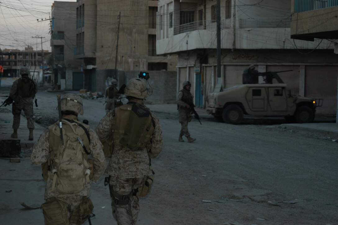 AR RAMADI, Iraq (March 18, 2005) - It was getting dark by the time the Marines with Company A, 1st Battalion, 5th Marine Regiment concluded their patrol. Marines with Company A, 1st Battalion, 5th Marine Regiment patrolled through the busy marketplace here in an effort to become more familiar with their area of operations and make their presents know to the local populace. The Marines also searched several building and a nearby mosque for weapons caches and insurgents. The three-hour patrol ended with the Marine returning empty handed to their base camp at Hurricane Point. Photo by Cpl. Tom Sloan