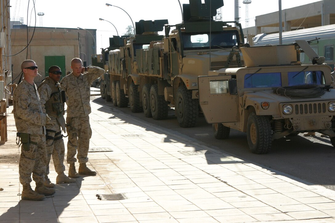 CAMP AL QA'IM, Iraq (March 18, 2005)- Sgt. Clive S. Chinatomby (middle), 29, a squad leader with the security platoon of 3rd Battalion, 2d Marine Regiment talks to his Marines before a convoy here. The Queens, N.Y., native was in the rear vehicle of the convoy, which was responsible for rear security. The convoy was to resupply Marines with Company I in Husaybah. Official U.S. Marine Corps photo by Lance Cpl. Lucian Friel (RELEASED)