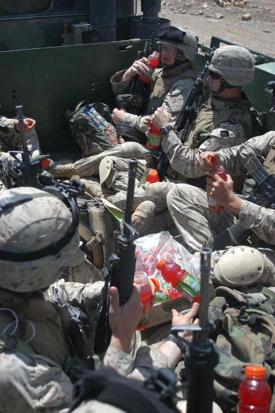 AR RAMADI, Iraq (April 18, 2005) -Knowing the importance of hydration, Marines with 3rd Platoon, Company C, 1st Battalion, 5th Marine Regiment, sit in the back of a 7-ton truck and drink Gatorade before hitting the streets and conducting an aggressive combat patrol. The Marines revisited a portion of the city here where, just two weeks ago, they engaged insurgents in the biggest firefight they've had since deploying here in early March. Nothing happened during this patrol, however, and the warriors returned safely to their firm base, Camp Snake Pit. Photo by Cpl. Tom Sloan.