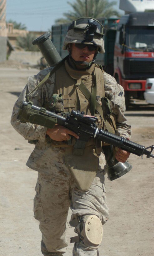 AR RAMADI, Iraq (April 18, 2005) -Lance Cpl. Angel R. Campos, a mortar man with 3rd Squad, 3rd Platoon, Company C, 1st Battalion, 5th Marine Regiment, expects the worst as he walks down a street with his weapon in hand. The 20-year-old from San Diego joined other Marines with 3rd Platoon, Company C, 1st Battalion, 5th Marines, in visiting a portion of the city here where, just two weeks ago, they engaged insurgents in the biggest firefight they've had since deploying here in early March. Nothing happened during this patrol, however, and the warriors returned safely to their firm base, Camp Snake Pit. Photo by Cpl. Tom Sloan