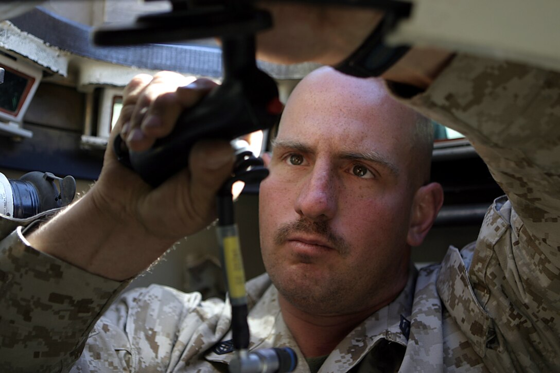 Haditha Dam, Al Anbar, Iraq - Gunnery Sgt. Richard J. Layton, 31 of 29 Plams, Calif., and tank commander of 3rd platoon, 1st Tank battalion  attached to 3/25 repairs hand control in his M1-A1 tank before they go out on thier next mission.