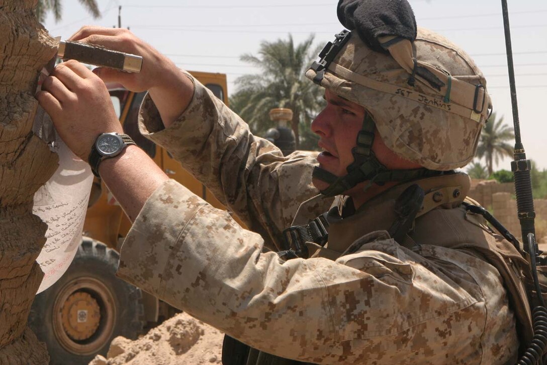 CAMP DELTA, Iraq -- Marines of Company I, 3rd Battalion, 8th Marine Regiment placed posters around local communities of known insurgents in the area.  Sergeant Nicholas W. Jenkins lead his squad through farmlands and small villages to make sure everyone knew who the insurgents were in their neighborhoods.  Official U.S. Marine Corps photo by Lance Cpl. Athanasios L. Genos