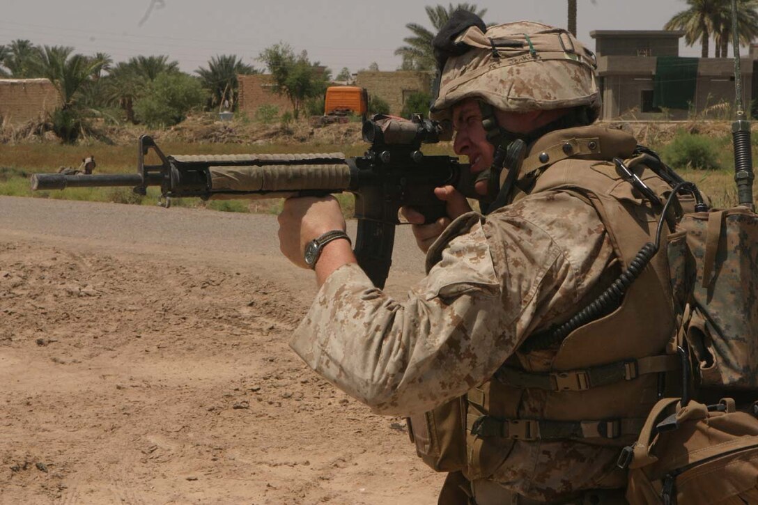 CAMP DELTA, Iraq -- Sergeant Nicholas W. Jenkins sights in on something he sees in the distance to check and make sure no one is placing IED's or setting up mortar sites on the Marines counter-indirect fire operations.  Official U.S. Marine Corps photo by Lance Cpl. Athanasios L. Genos