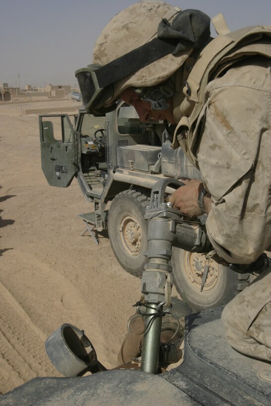 KARBALAH, Iraq- (June 18, 2005)  Lance Cpl. Randy L. Williamson, a Marine from 2D Light Armored Reconnaissance, Charlie Company refuels his Light Armored Vehicle at a forward refueling point. Lance Cpl. Williamson is from East Stroudsburg, Pa. During Operation Spear, the Marines of 2d Marine Division conduct counter- insurgency operations with Iraqi Security Forces to isolate and neutralize anti-Iraqi forces, to support the continued development of Iraqi Security Forces, and to support Iraqi reconstruction and democratic elections in order to create a secure environment that enables Iraqi self-reliance and self-governance.