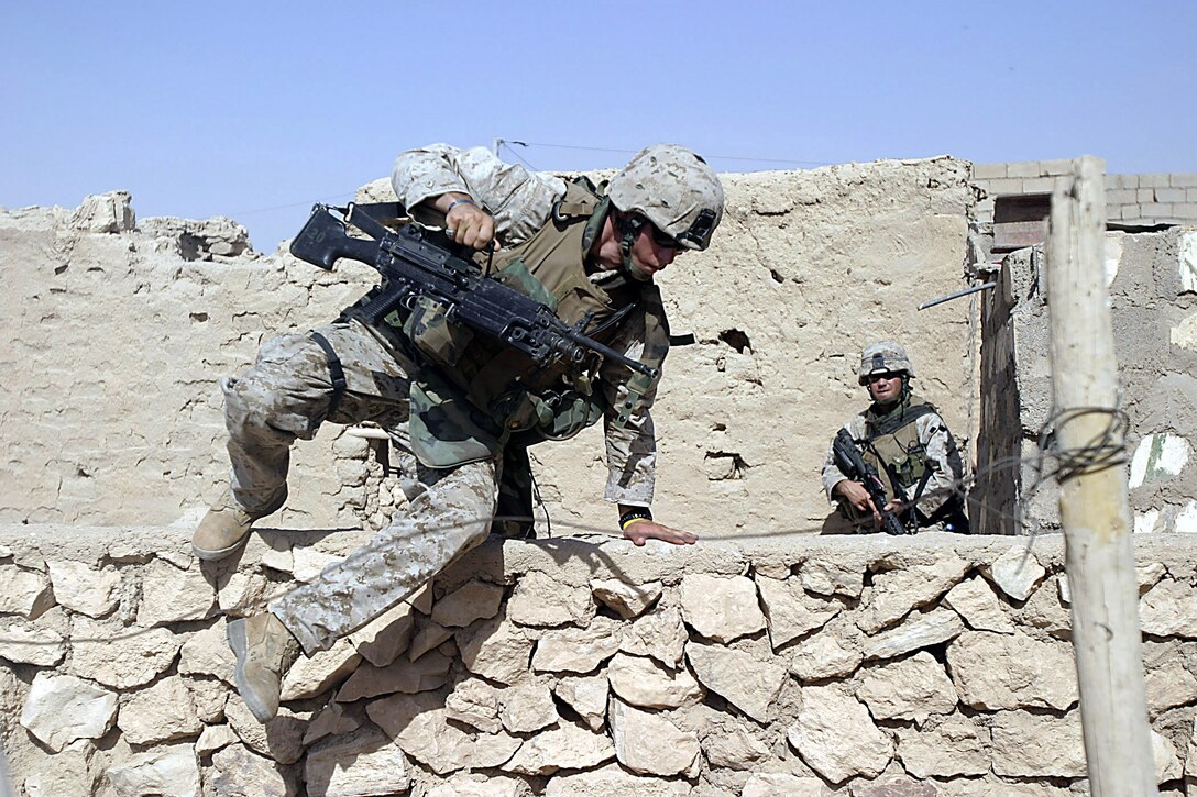 Karabilah, Al Anbar, Iraq (June 18, 2005)-- Marines with 2nd platoon, Lima Co., 3/25 climb over walls so they can complete thier mission in Karabilah during Operation Spear. (Official USMC Photo by Corporal Ken Melton)