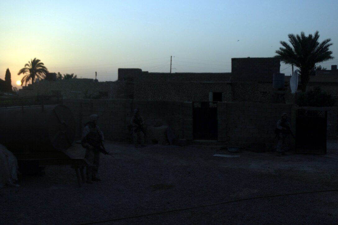 Karabilah, Al Anbar, Iraq (June 18, 2005)-- Marines with 2nd platoon, Lima Co., 3/25 stay alert even as a white flag hovers above them in Karabilah during Operation Spear. (Official USMC Photo by Corporal Ken Melton)