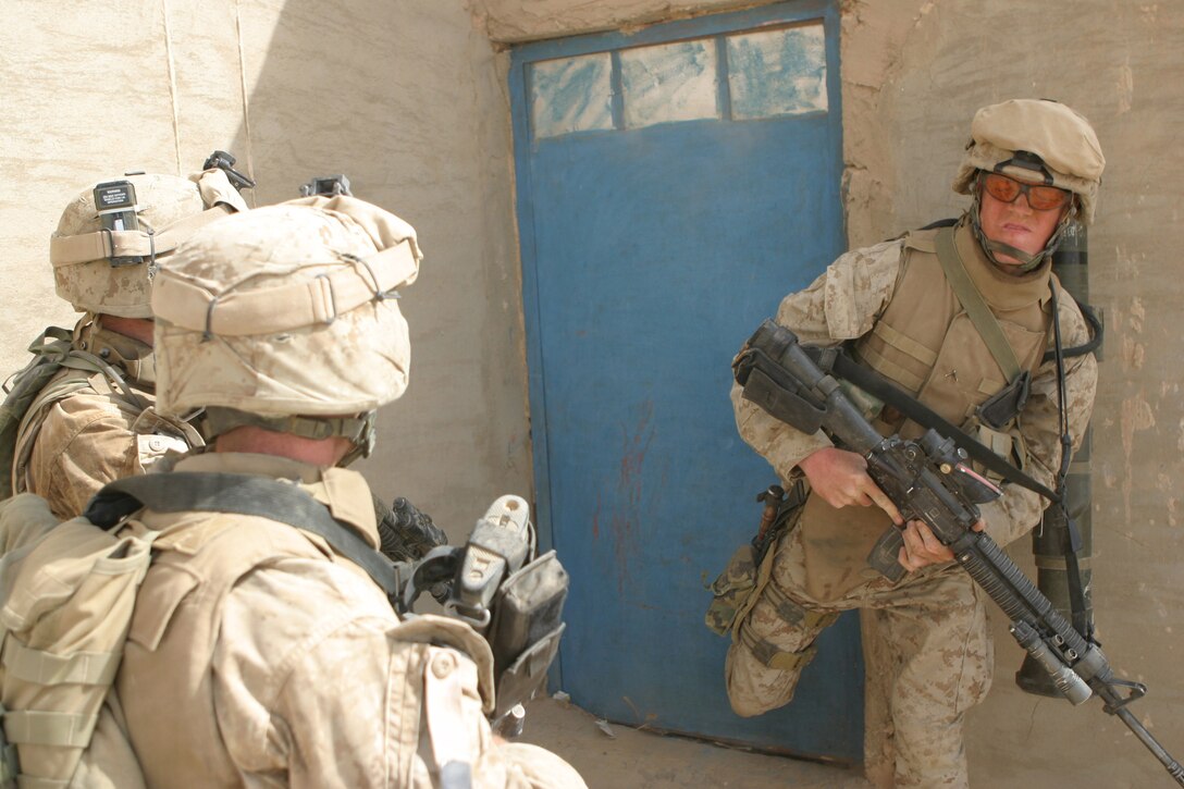 LAKE THARTHAR REGION, Iraq - A Marine with Task Force Hard donkey kicks a farm house storage closet door during a patrol, June 19, for Operation Khandjar (Iraqi for dagger).  The Task Force primarily involved Marines with 1st Battalion, 6th Marine Regiment, who from June 17 through the 22nd searched for insurgent weapons caches.  U.S. Marine Corps photo by Sgt. Stephen D'Alessio (RELEASED