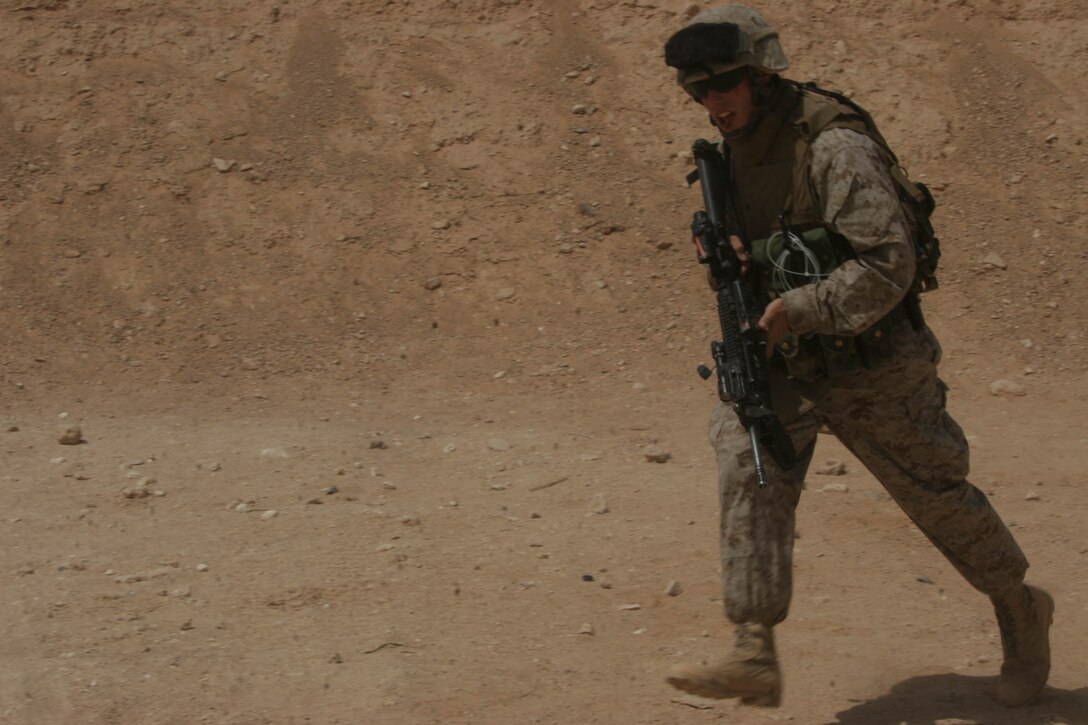 003-AL QA'IM, Iraq (July 16, 2005)- Lance Cpl. Benjamin D. Hallstrom, 22, a team leader with 2nd Platoon, Company K, 3rd Battalion, 2nd Marine Regiment, Regimental Combat Team-2 runs to an objective. The Clearwater, Fla., native wants to write a book about his experiences during Operation Iraqi Freedom III to educate the American public. (Official U.S. Marine Corps photo by Lance Cpl. Lucian Friel (RELEASED)