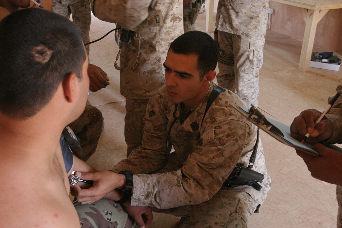CAMP AL QA'IM, Iraq (July 18, 2005)- Hospital Corpsman 3rd Class (FMF) Roman Cadena, Jr., a corpsman with 3rd Battalion, 2nd Marine Regiment, Regimental Combat Team-2 from Weslaco, Texas, checks an Iraqi soldiers blood pressure during a medical screening here. (Official U.S. Marine Corps photo by Lance Cpl. Lucian Friel (RELEASED)