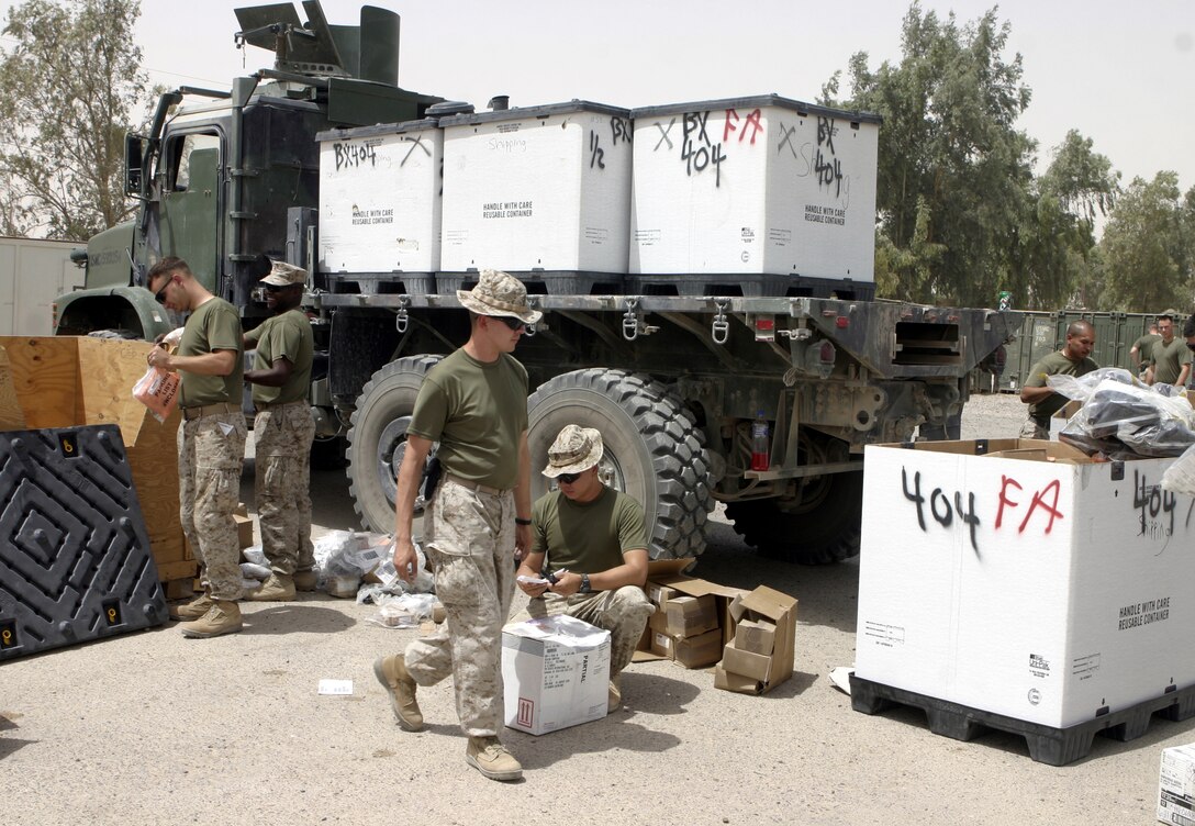 CAMP BAHARIA, Iraq - Marines with 1st Battalion, 6th Marine Regiment's supply section unpack and sort through boxes of equipment outside their camp's shop.  The battalion's supply Marines store and keep track of millions of dollars worth of equipment their unit's infantrymen use to conduct counterinsurgency operations in and around Fallujah.