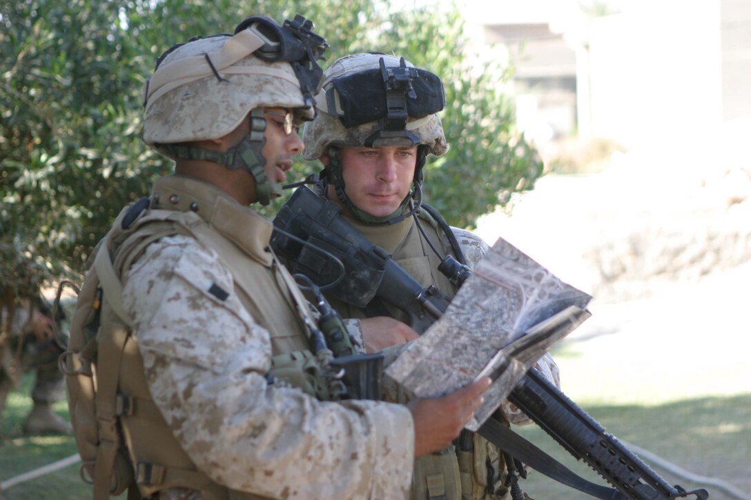 CAMP BLUE DIAMOND, RAMADI, Iraq -  Sergeant Mohamed S. Salim a platoon sergeant with Company L, 3rd Battalion, 10th Marine Regiment looks over a map with a fellow Marines before deciding which route to take during a routine patrol. Salim and the Marines from his platoon have conducts nearly 100 patrols through the streets of Ar Ramadi that surround the camp here. Official U.S. Marine Corps photo by Sgt. Ryan S. Scranton