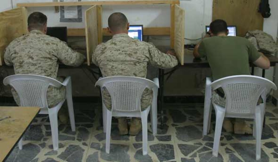 Marines from 2nd Battalion, 6th Marines surf the internet at the phone center on Camp Baharia. The phone center stays open 24 hours a day; 7 days a week due to the dedicated support of the corpsmen who man the front desk and make sure every Marine gets a chance to use the phone or computer.