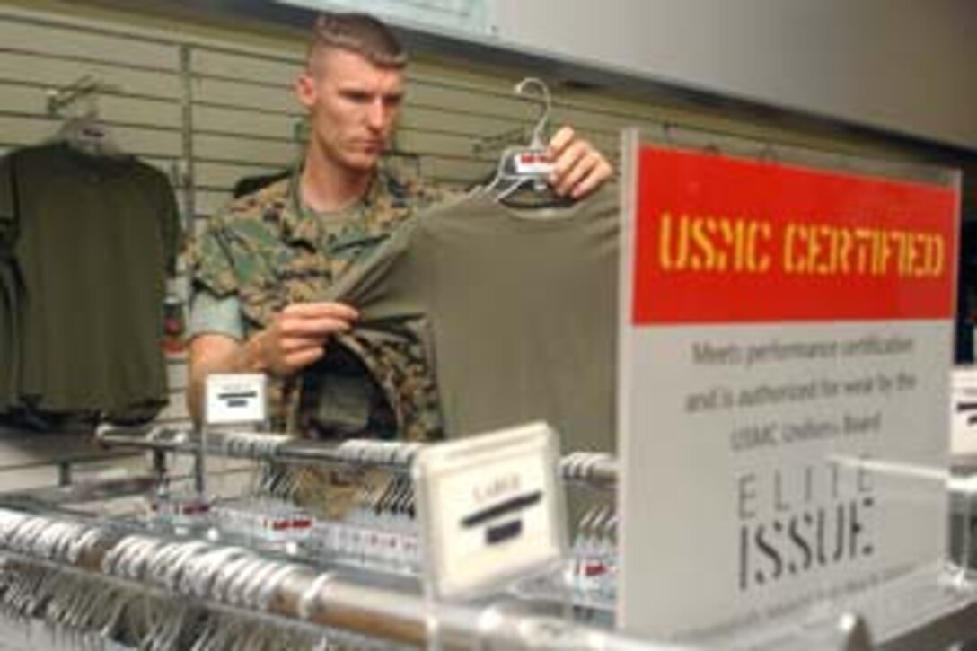 MARINE CORPS BASE CAMP LEJEUNE, N.C. - Lance Cpl. Aaron T. Williams, a rifleman with Company L, 3rd Battalion, 8th Marine Regiment, 2nd Marine Division, looks through a rack of Elite Issue shirts for the first time. Developed by Danskin, Inc., Elite Issue shirts are USMC certified with anti-microbial, anti-odor and anti-mositure technology.
