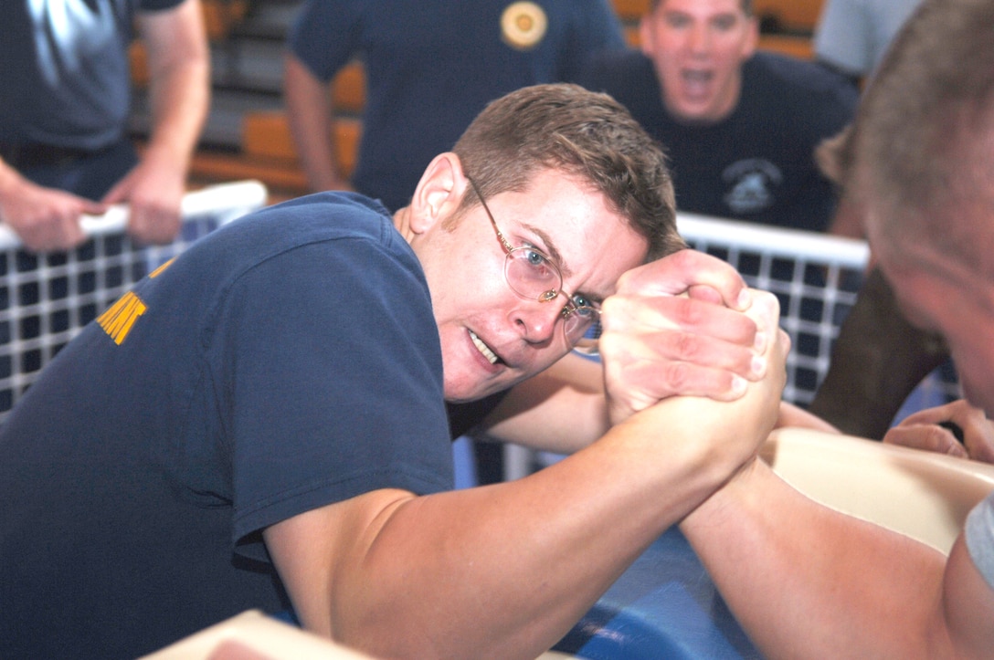 Coast Guard Petty Officer 2nd Class Cory Yates clenches fists with Gunnery Sgt. Paul Agan, Recruit Training Regiment. Agan won and took first place.
