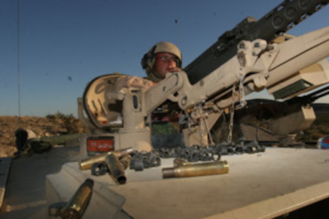 Sergeant Wes Scott, tank commander, 3rd Platoon, Delta Company, 1st Tank Battalion, sits behind his M2 .50 caliber machine gun and glares at the soon-to-be destroyed targets for a second round of heavy machine gun fire on Table 5, a heavy machine gun assault course at Combat Center Range 500.  The unit, along with the battalion master gunner and the company commander, executed their gunnery qualification Aug. 16 to 20, to qualify the crewmen in assault engagements.