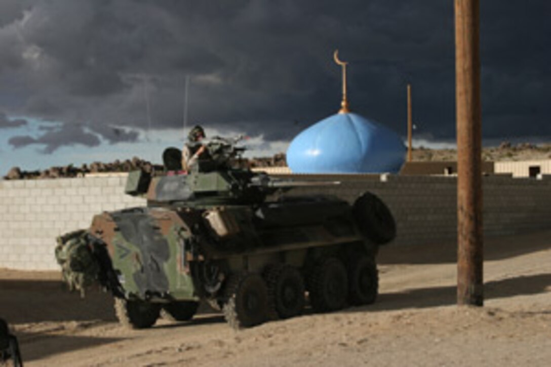 Corporal Brandon M. Stein, light armored vehicle commander with Charlie Company, 3rd Light Armored Reconnaissance Battalion, glares into the military operations on urban terrain town at the Combat Center?s Range 200 Oct. 18 gripping the LAV?s coaxial M240G machine gun and prepared to fire-off his loaded blanks.  The 24-year-old Tehachapia, Calif., native and the rest of the company raided the range the week of Oct. 18 to prepare the company for their upcoming deployment.