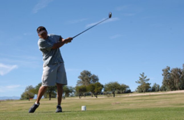 Rogelio Zamora, Exercise Support Division, tees off in the 3rd Annual Toys for Tots Golf Tournament Nov. 18 at Desert Winds Golf Course.