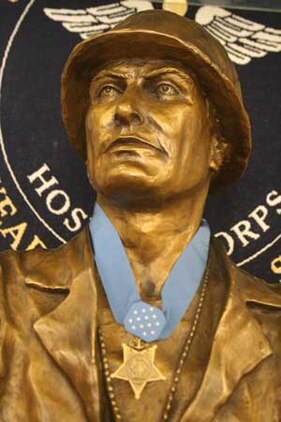 A cast bronze bust of Robert E. Bush sits on display at the Robert E. Bush Naval Hospital wearing a replica of his Congressional Medal of Honor which he received for his actions on Okinawa in 1945.  Bush passed away Nov. 8 after a battle with cancer and was honored by a memorial service Nov. 18 at the hospital.