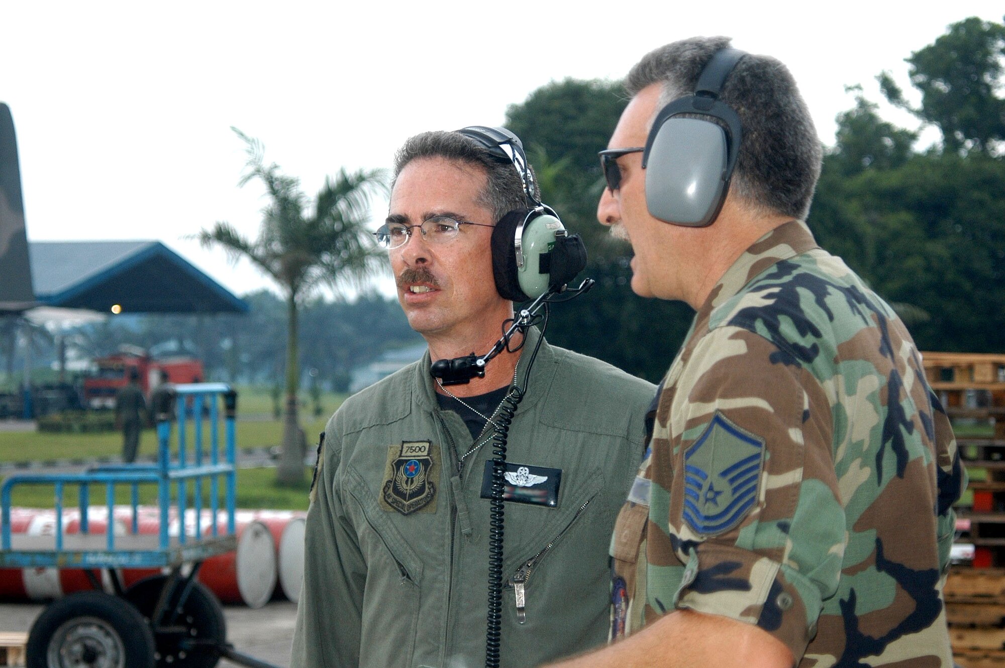 MEDAN, Indonesia -- An Airman (left) with the 17th Special Operations Squadron at Kadena Air Base, Japan, talks with a ramp leader here.  (Digitally altered U.S. Air Force photo by Master Sgt. Michael Farris)

