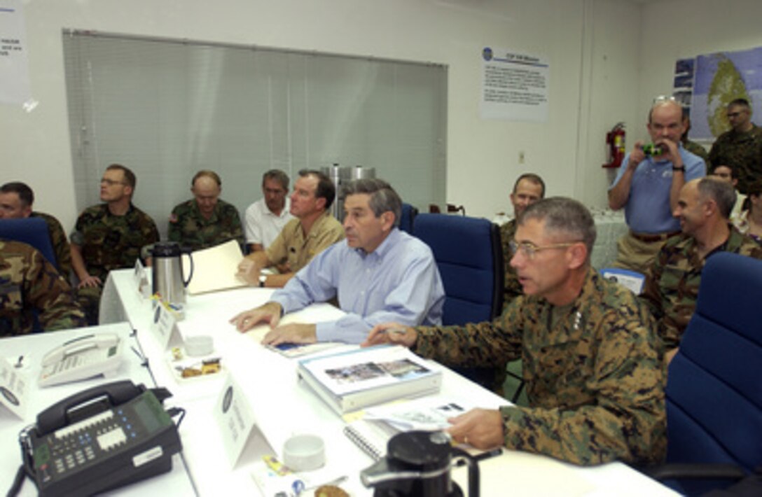 Deputy Secretary of Defense Paul Wolfowitz (center) and Navy Adm. Tom Fargo, commander Pacific Command (left) receive a disaster assessment briefing from Marine Lt. Gen. Rodger Blackman (right), commander Combined Support Force 536 at Utaphao, Thailand, on Jan. 15, 2005. Wolfowitz is in Utaphao to meet regional commanders and thank the U.S. service men and women who are providing humanitarian assistance to areas devastated by the Dec. 26, 2004, Indian Ocean tsunami as part of Operation Unified Assistance. 