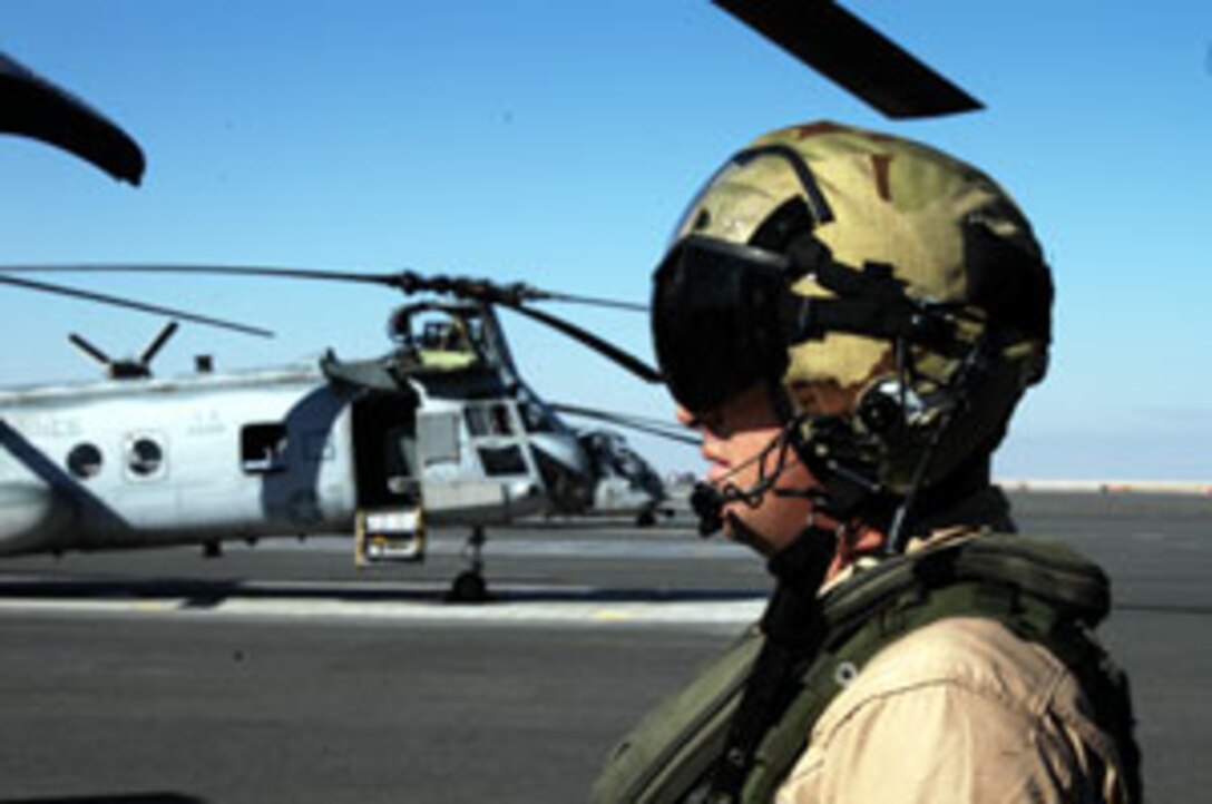 Gunnery Sgt. Brian Rogers, CH-46E maintenance control staff noncommissioned officer in charge with Marine Medium Helicopter Squadron 165 (REIN), watches his Marines as they start the helicopter before a mission. Rogers, working as a crew chief for this mission, were set to fly a terrain flight to get them ready for future operations over land.