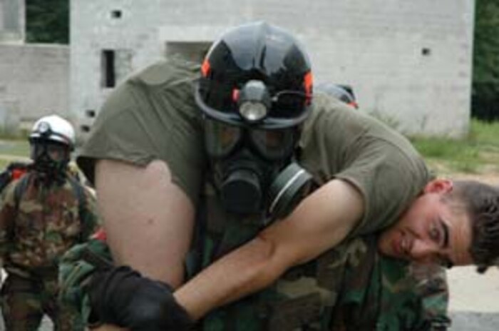 QUANTICO, Va. - A Marine from the Chemical Biological Incident Response Force carries a casualty to the decontamination line during a simulated chemical attack evolution August 18. The CBIRF Marines strive to maintain top physical condition in order to increase their effectiveness in the event of responding to a real-world incident.