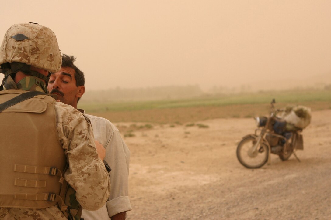 CAMP HADITHAH, Iraq -- Sergeant Robert Waltz, a 30-year-old Cleveland, Ohio native and assault section leader with Company L, 3rd Battalion, 25th Marine Regiment interviews an Iraqi during a search, April 19.  The 1994 Bishop Hartley High School graduate conducted a search with his platoon for roadside bombs and mortar positions.  The search was prompted by a recent mortar attack that hit the dam.  Two Iraqis were found with a rifle, explosives and bomb making material.  U.S. Marine Corps photo by Sgt. Stephen D'Alessio (RELEASED)