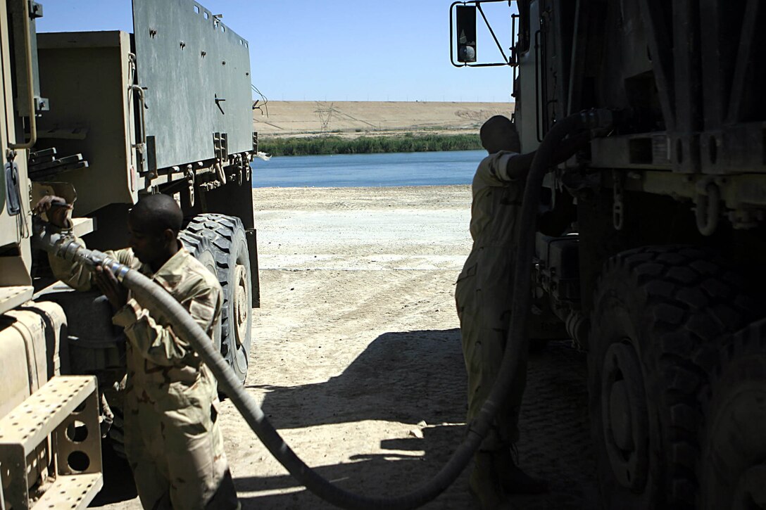 Haditha Dam, Al Anbar, Iraq (May 6, 2005)--Cpl. Charles E. Stasher, 24 of Pickens, Miss., native, and a refuel chief with 3rd Battalion, 25th Marines, and Lance Cpl. Terrence L. Burns, 24 of Rolling Forks, Miss., and motor transport operator refuel a vhecile as it comes back from a mission. (Official USMC Photo by Corporal Ken Melton)
