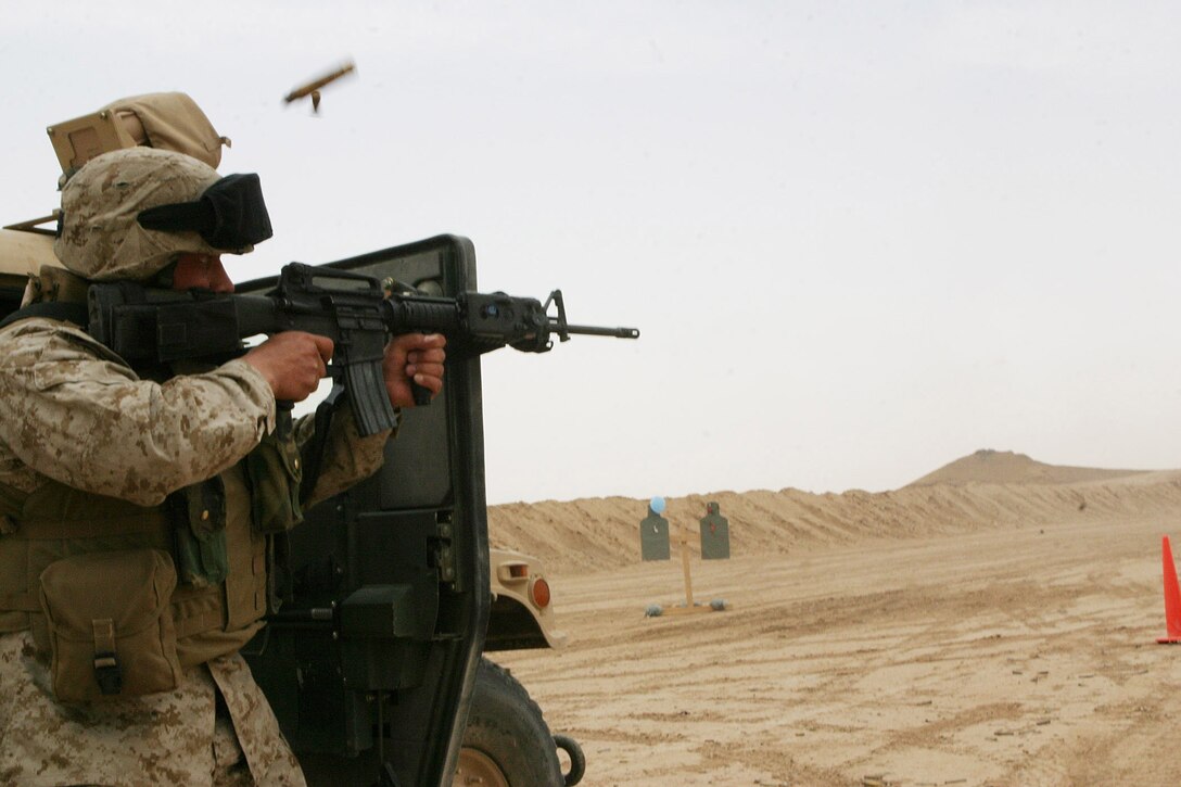 CAMP RAMADI, AR RAMADI, Iraq - Sergeant Macario Ruiz, a 29-year-old Dallas native and motor transportation operator with Truck Company, Headquarters Battalion, 2nd Marine Division, fires his M-16 A4 service rifle at paper targets during a live fire and maneuver exercise, May 12, designed specifically to combat the insurgency.  Ruiz is a 1994 Skyline High School graduate.  U.S. Marine Corps photo by Sgt. Stephen D'Alessio (RELEASED)