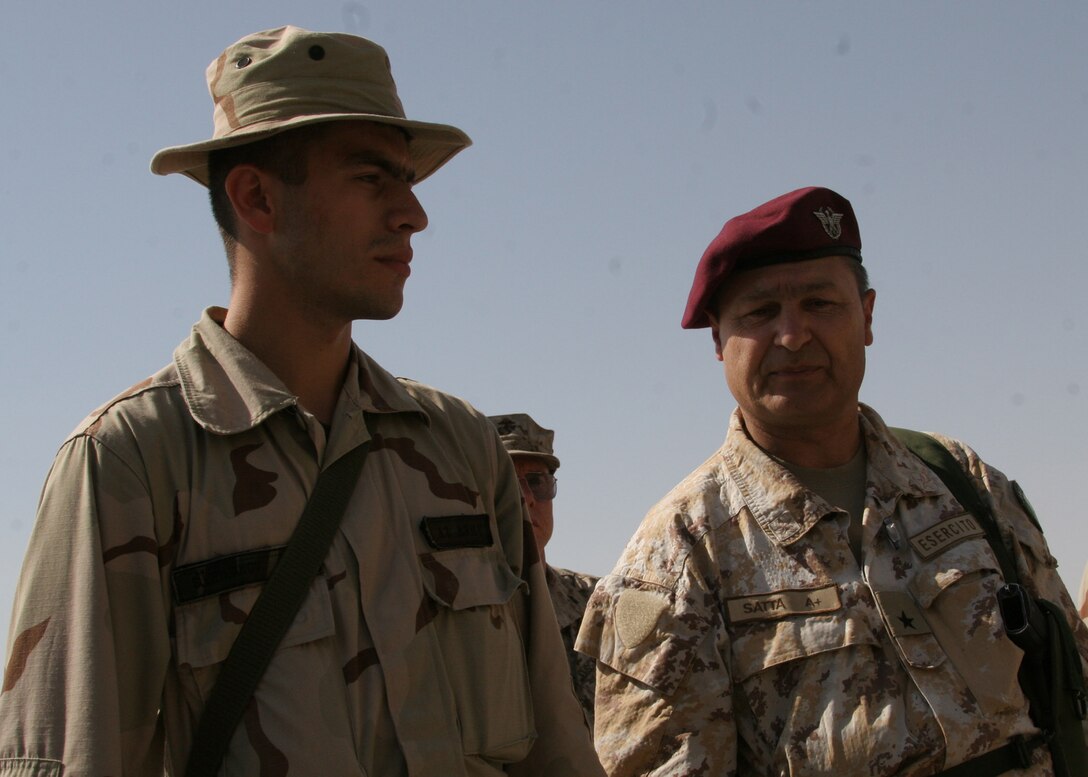 Hadithah, Al Anbar, Iraq.-- Azerbaijani Pvt. Suleymanov translates for Italian Brig. Gen. Antonio Satta.  Suleymanov translated the general's speech, given in English, to Azeri, the language of the Azerbaijanis.  "Suley" speaks fluent Azeri, English, and Spanish.  Italian language courses are popular among Azerbaijani officers.  (Photo by Lance Cpl. Marc Fencil. )