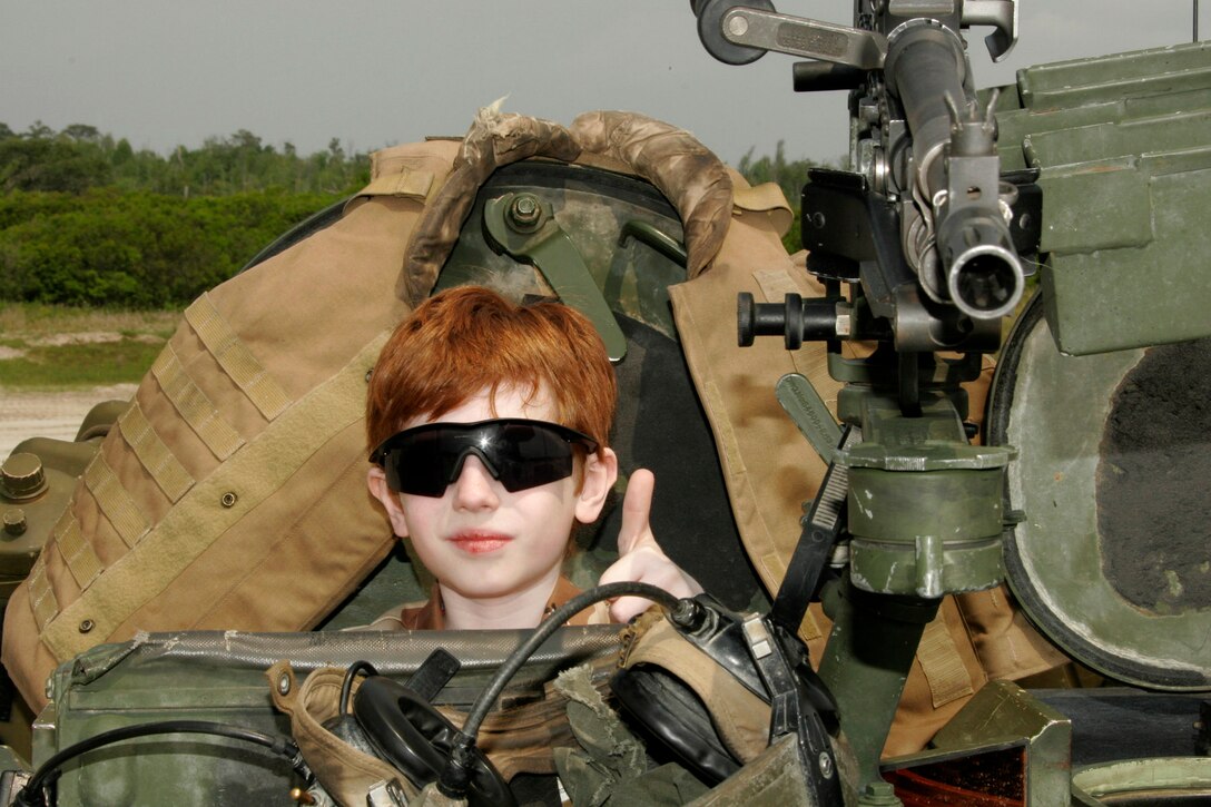 MARINE CORPS BASE CAMP LEJEUNE, N.C. - In conjunction with the Make-A-Wish Foundation, Angelo J. Circo, "AJ", and his family traveled here from Brookfield, Ill. to witness the II Marine Expeditionary Force Capabilities Exercise May 19.  As part of his visit, AJ got to ride in an M1A1 Abrams main battle tank, pull the lanyard on a Howitzer, and speak one-on-one with Lt. General James F. Amos, the commanding general for II MEF.