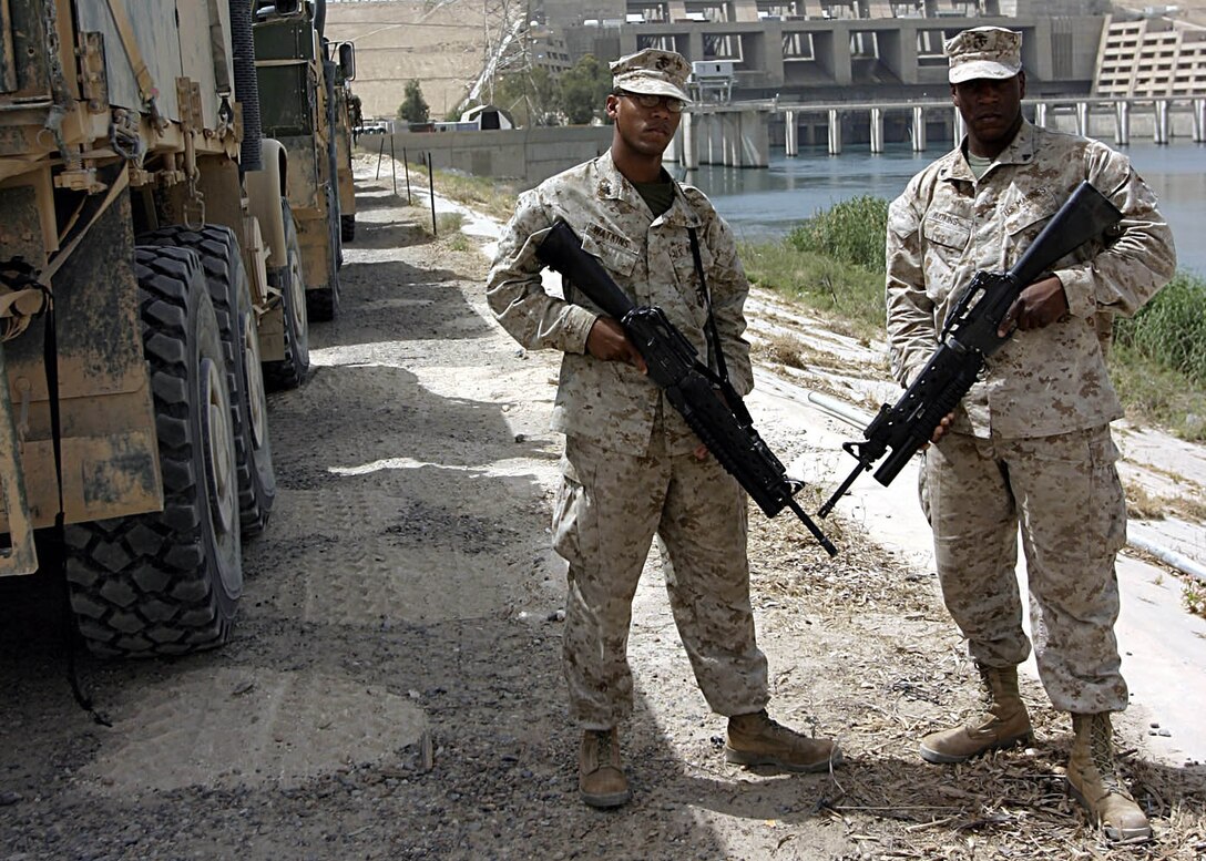 Haditha, Al Anbar, Iraq (May 21, 2005) - Field radio operator with 3rd Battalion, 25th Marine Regiment, Cpl. Willie O. Watkins, 23, and his  22-year-old brother motor transportation operator Cpl. Clifton C. Watkins, both from McComb, Miss., enjoy a moment together before going out on their next mission.  (Official USMC photo by Cpl. Ken Melton)
