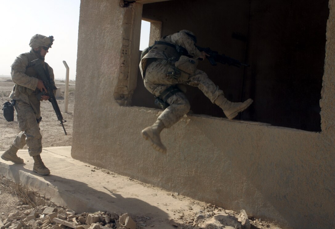 THAR THAR REGION, Iraq - A Marine from 2nd Squad, 2nd Platoon, Company B, 1st Battalion, 6th Marine Regiment enters a ruined building here June 19 and prepares to search through it for weapons and explosives.  Company B personnel participated in Operation Dagger, a five-day long effort to rid regions north of Fallujah of insurgent activity.