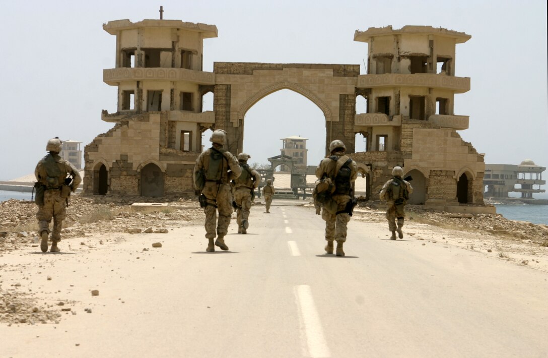 THAR THAR REGION, Iraq - Marines with 2nd Squad, 2nd Platoon, Company B, 1st Battalion, 6th Marine Regiment patrol toward a ruined structure bordering Thar Thar Lake's shoreline June 19.  Company B personnel participated in Operation Dagger, a five-day long effort to rid regions north of Fallujah of insurgent activity.