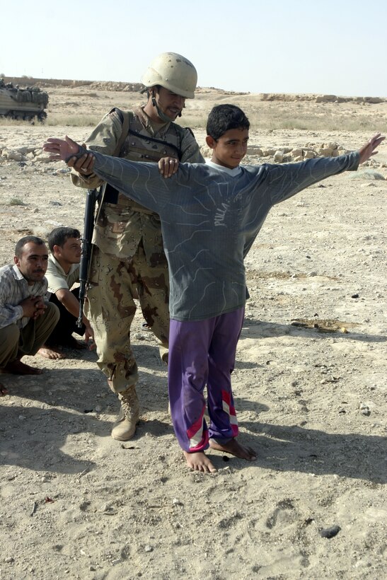 THAR THAR REGION, Iraq - An Iraqi soldier searches a fisherman for weapons along the shores of the Thar Thar Lake June 19.  The Iraqi soldiers assisted U.S. personnel during Operation Dagger, a five-day long effort to rid regions north of Fallujah of insurgent activity.