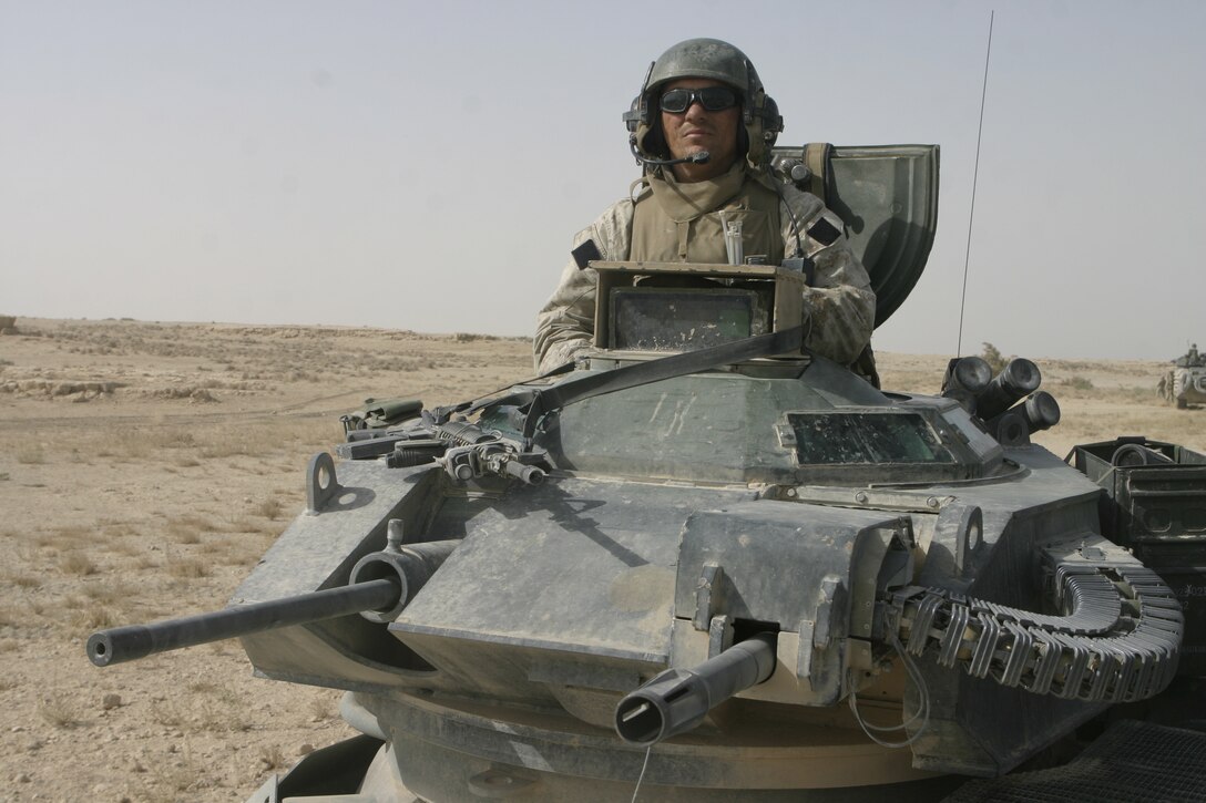 THAR THAR REGION, Iraq - Sgt. Steven Phillips, an amphibious assault vehicle crew chief with Company B, 2nd Assault Amphibian Battalion, stands behind his vehicle's weapons turret as he scans the horizons here for insurgent activity.  The 27-year-old Vidor, Texas native and several fellow AAV crewmen recently assisted 1st Battalion, 6th Marine Regiment personnel in conducting Operation Dagger, a five-day long effort to rid regions north of Fallujah of insurgent activity.