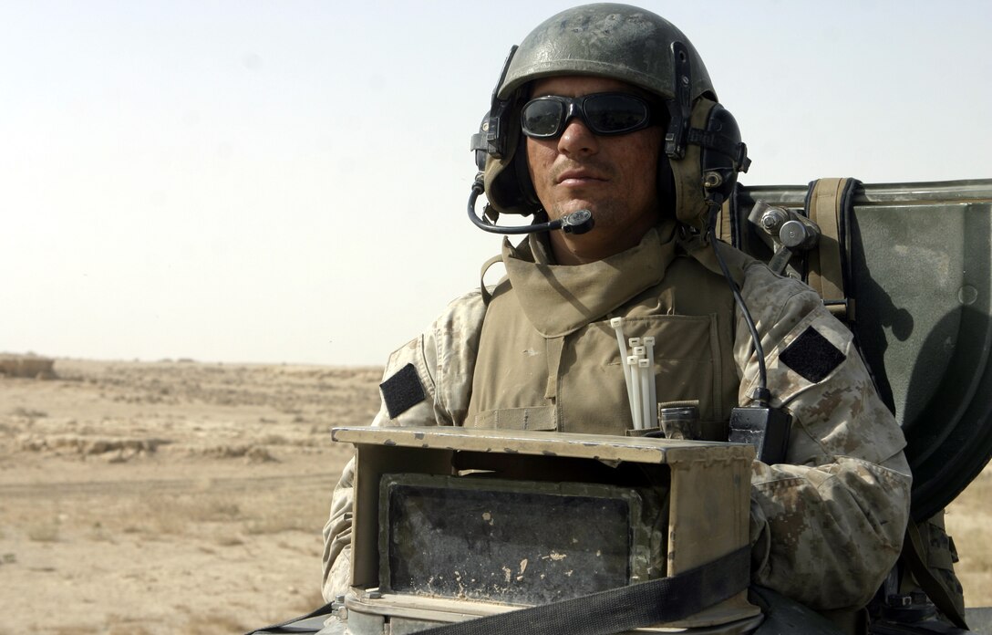 THAR THAR REGION, Iraq - Sgt. Steven Phillips, an amphibious assault vehicle crew chief with Company B, 2nd Assault Amphibian Battalion, stands behind his vehicle's weapons turret as he scans the horizons here for insurgent activity.  The 27-year-old Vidor, Texas native and several fellow AAV crewmen recently assisted 1st Battalion, 6th Marine Regiment personnel in conducting Operation Dagger, a five-day long effort to rid regions north of Fallujah of insurgent activity.