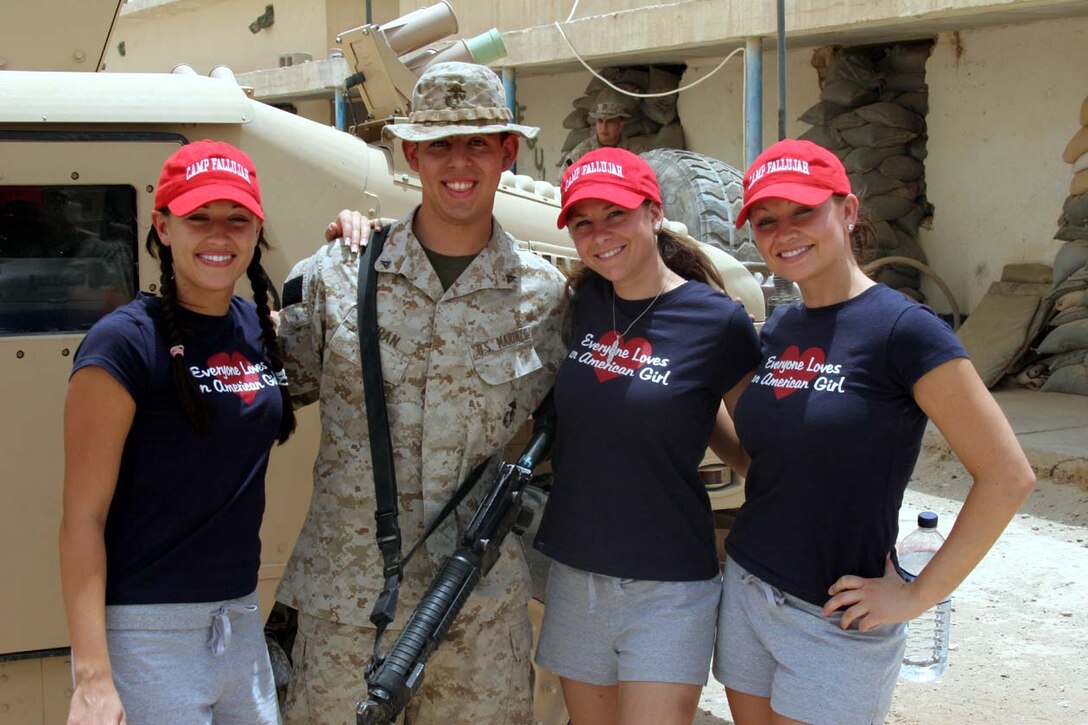 CAMP FALLUJAH, Iraq -- Lance Cpl. Jeremy M. Duran, a Wickenburg, Az., native, met with the cheerleaders from his home area.  The cheerleaders took many pictures with all who wanted to have them taken.  Official U.S. Marine Corps photo by Lance Cpl. Athanasios L. Genos