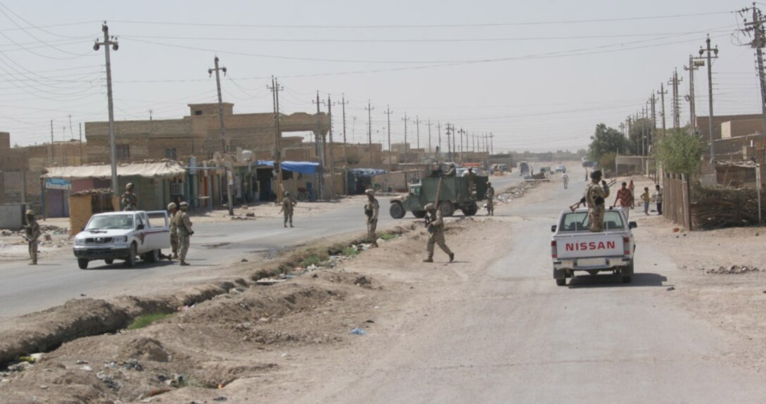 050819-M-2607O-001 CAMP FALLUJAH, Iraq -- Marines and Iraqi Army with 2nd Battalion, 2nd Marine Regiment set up security during a hult on a routine patrol 19 Aug.  The Iraqi Army is taking the lead when doing searches in local villages so they are proficient when the U.S Military finally leaves Iraq.