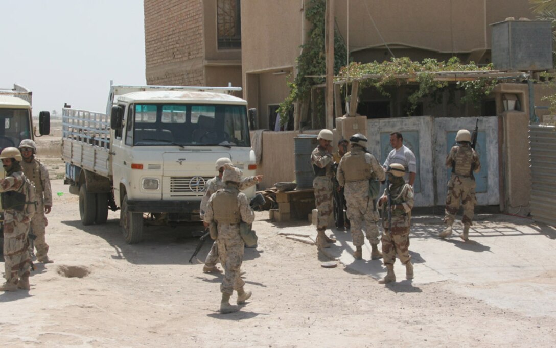 050819-M-2607O-002 CAMP FALLUJAH, Iraq -- Marines and Iraqi Army with 2nd Battalion, 2nd Marine Regiment greet the locals of this residence before they ask to serach the premasis in a routine patrol 19 Aug.  The Iraqi Army is taking the lead when doing searches in local villages so they are proficient when the U.S Military finally leaves Iraq.