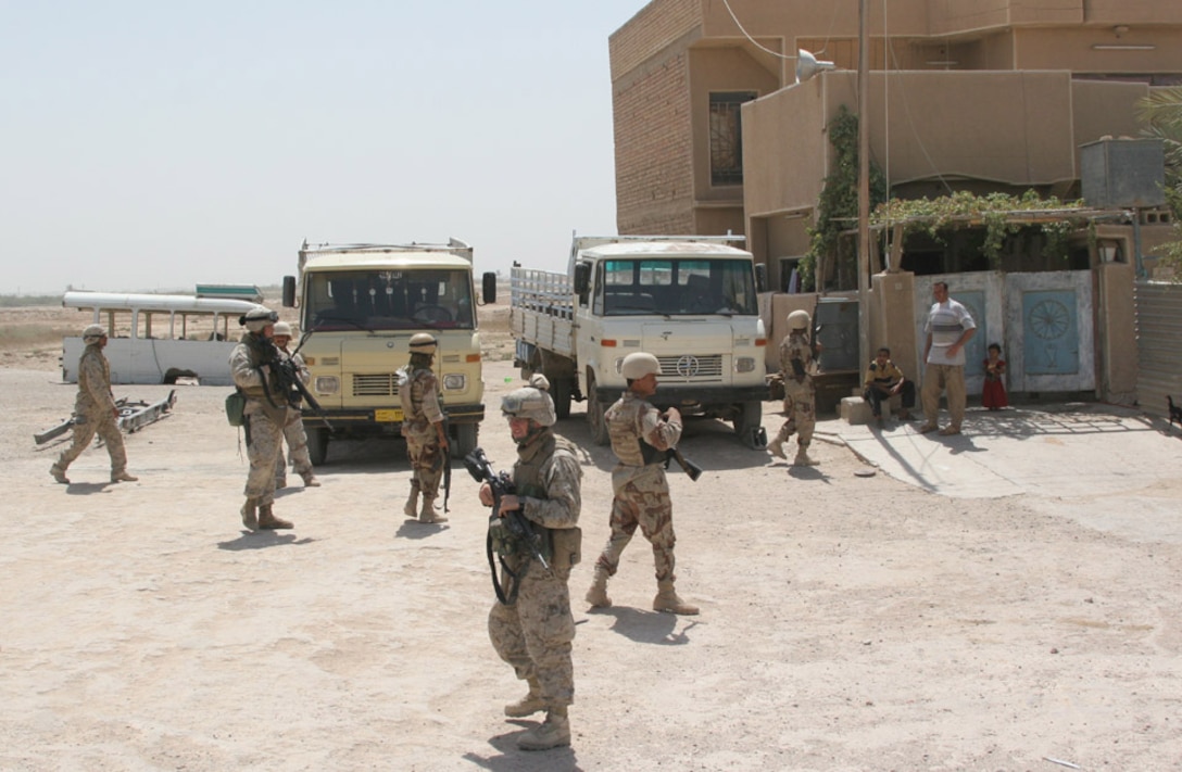 050819-M-2607O-004 CAMP FALLUJAH, Iraq -- Marines and Iraqi Army from Cpl. Michael P. Hodshire, 2nd squad leader for 3rd Platoon, Easy Company, squad enter a locals house to search the premesis to see if there is anything there that shouldn't be.  Hodshire does this often to make sure the locals know we are here and that we are here to help.