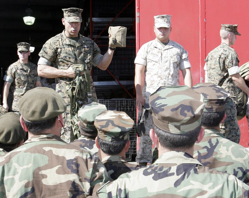 Maj. Christian H. Veeris, Chile exchange officer, Marine Forces South, explains the Improved First Aid Kit to Chilean marines from the Chilean Amphibious Brigade. The Chileans are here as participants in the annual Centauro Exchange Program, the purpose of which is to foster close international relations and build a joint sense of esprit de corps, said 10th Marines commanding officer Lt. Col. Christopher T. Mayette.