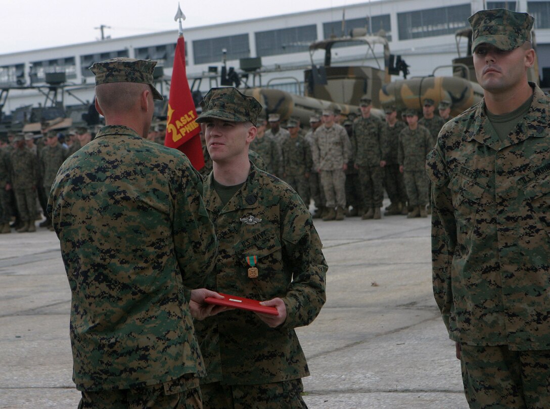 MARINE CORPS BASE CAMP LEJEUNE, N.C. (Nov. 16, 2005) - P.O. Joshua G. Chambers received the Navy and Marine Corps Commendation medal in a ceremony here, Nov 10.  Ten Marines with the 2nd Assault Amphibian Battalion received Purple Heart medals, and 10 Marines along with Chambers received Navy and Marine Corps Commendation medals.