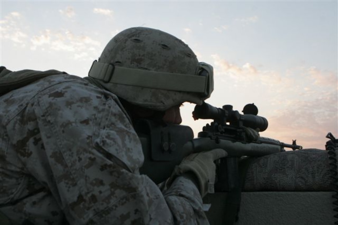 UBAYDI, Iraq ? Providing security, Petty Officer 1st Class Shepley A. Reimer, 30, of Colorado Springs, Colorado, and Reconnaissance Platoon corpsman with 1st Platoon, Company A, watches thru the scope of his M-14 sniper rifle on a rooftop here Nov. 19. For Recon Marines, their specialized jobs are vital in supporting infantry Marines on the advance.
