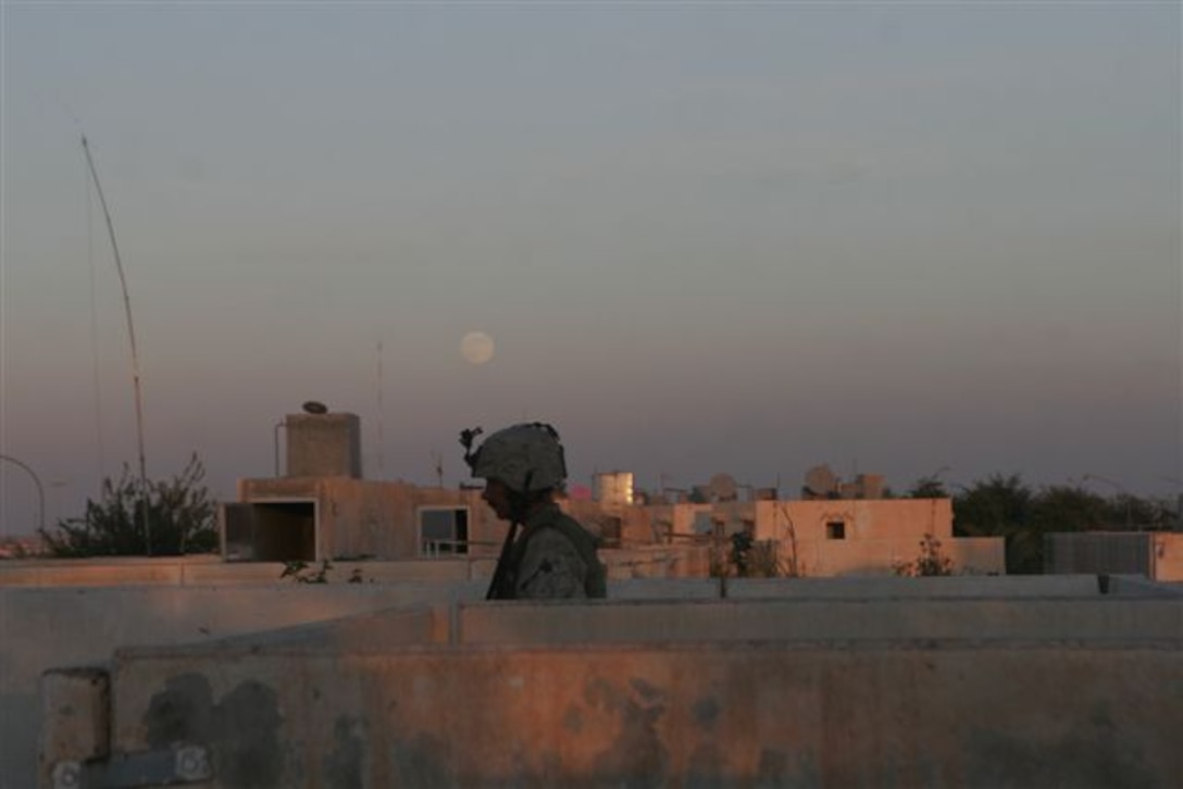UBAYDI, Iraq ? As the moon rises over the rooftops here, a Marine with 1st Platoon, Company A, keeps watch Nov. 15. The security Recon Marines provided was vital in supporting infantry Marines in their house-to-house, block-to-block advance during Operation Steel Curtain.